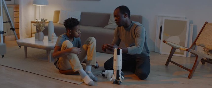 African American father and son playing together, building moon landing mission rocket together. Stay home, quarantine, science. ARRI Alexa Mini