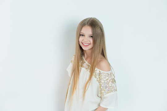 Smile, gorgeous. Portrait closeup of funny, excited joyful girl female child laughing kid smiling girl long hair looking at you isolated white background wall. Positive human emotion facial expression