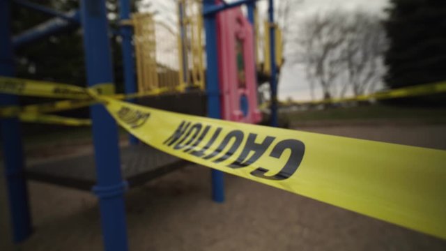 Children's Playground Is Closed. Focus On Yellow Caution Tape Due Coronavirus COVID-19 Pandemic. No Children On The Playground Is Allowed.  Ban On Children 's Playgrounds. The Fight With Virus.