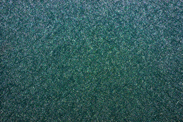 Beautiful shiny emerald surface with a fine pattern.