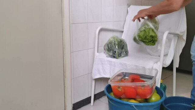 Quarantine. Pandemic. Woman unpacks and disinfects the fruits and vegetables so that her family is not contaminated. Taking care of viruses. 