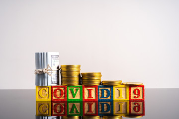 Coins stacking and letter wooden cube with health concept.