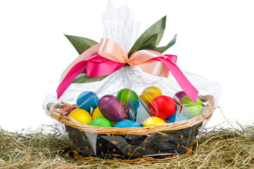 Easter gift basket with multicolor eggs, white background
