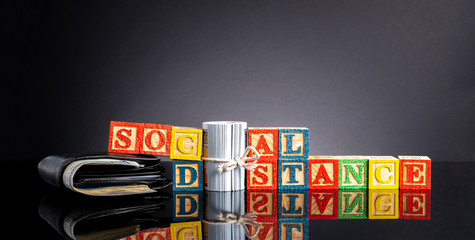 Social distance letter in wooden cube with black background.