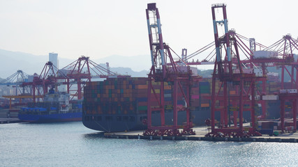 bright multi-colored containers on huge cargo barges in an industrial port. Large container ships...