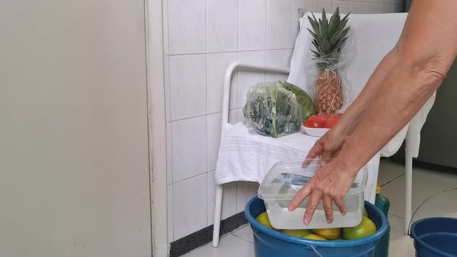 Quarantine. Pandemic. Woman unpacks and disinfects the fruits and vegetables so that her family is not contaminated. Taking care of viruses. 