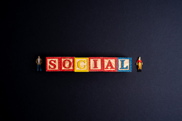 Social distance letter in wooden cube with black background.