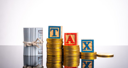 Tax letter in wooden cube with white background.