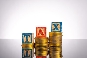 Tax letter in wooden cube with white background.