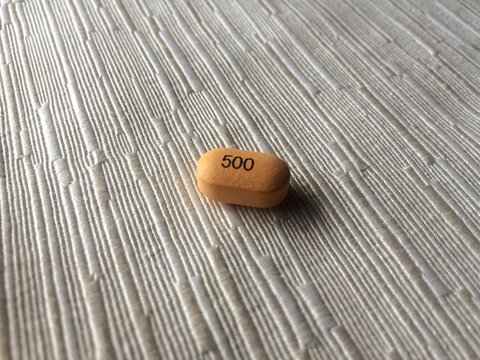 High Angle View Of Pill With Number On Table