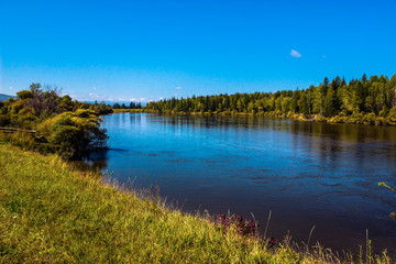 
Irkutsk region, Arshan, Irkut river. Green shores, blue sky and water