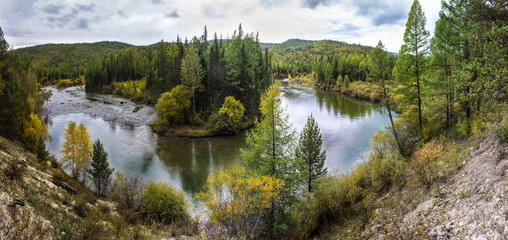 Beautiful landscape on the Irkut river.  A landscape view of the swift Irkut River, from the top of the hill. View of the tops of the forest and the river