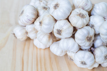 Garlic bulbs on wooden table..