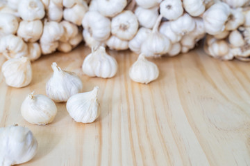 Closeup of Garlic bulbs on wooden table with garlics blur background.