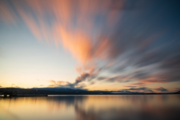 Purple, pink, blue late fall autumn sunset in northern Canada on a stunning, calm lake. Canadian sunsets in the fall. 
