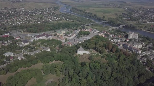 Aerial view of ruined medieval Halych Castle on the hill at sunny day with panorama to city Halych and river, Ivano-Frankivsk region, Ukraine