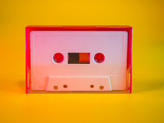 Audio cassette tape vintage analog recording medium from 1970's on yellow background