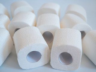 close up of a toilet paper roll on white background