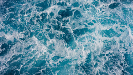 Abstraction of sea foam in the ocean. Light blue clear water, storm waves