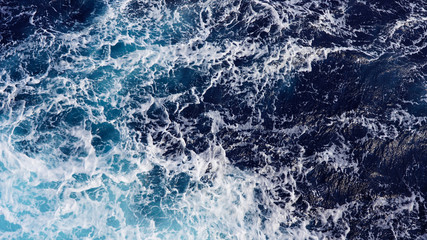 Fototapeta na wymiar Abstract background shot of sea water surface, foam streaks, sea splash, natural background