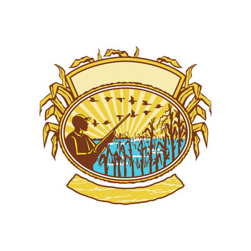 recommend clip art: Retro style illustration of a bird or duck hunter with rifle in flooded cornfield with corn stalks set inside oval shape with banner and sunburst on isolated white background.