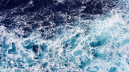 Fototapeta na wymiar Abstraction of sea foam in the ocean. Turquoise light water.