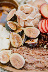 A close up of ripe figs on a charcuterie plate