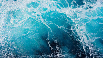 Blue frothy water surface, sea water background. Dark storm waves