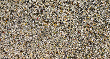 light gray asphalt texture with many colorful bright stones blue green yellow red colors
