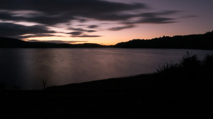 Fototapeta na wymiar Simple silhouette sunset shot on long shutter. Shot at New Zealand