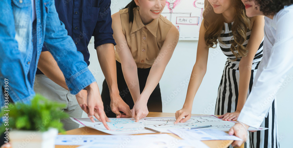 Wall mural group of asian young creative female employee happy casual meeting on a business meeting office back