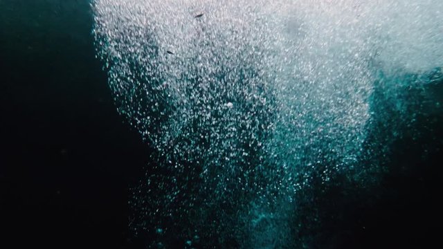 Mayan Man diving out of deep cave water slow motion underwater