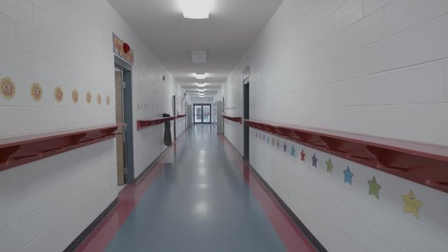 slowing moving down empty school hallway