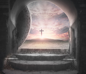 Easter Sunday concept: Tomb empty with cross on sunset background