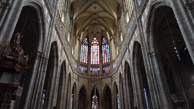 Pan up slow motion colorful stained glass inside beautiful church