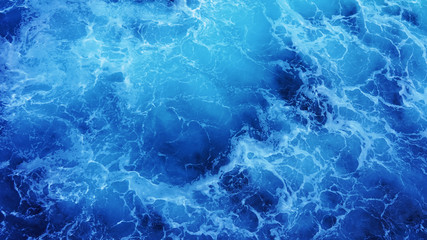 Abstraction of sea foam in the ocean. Dark water stormy waves turquoise pacific ocean water on a sunny day