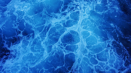 Close-up on blue ocean water on a sunny day, foaming water, sea texture, view from the deck of a...