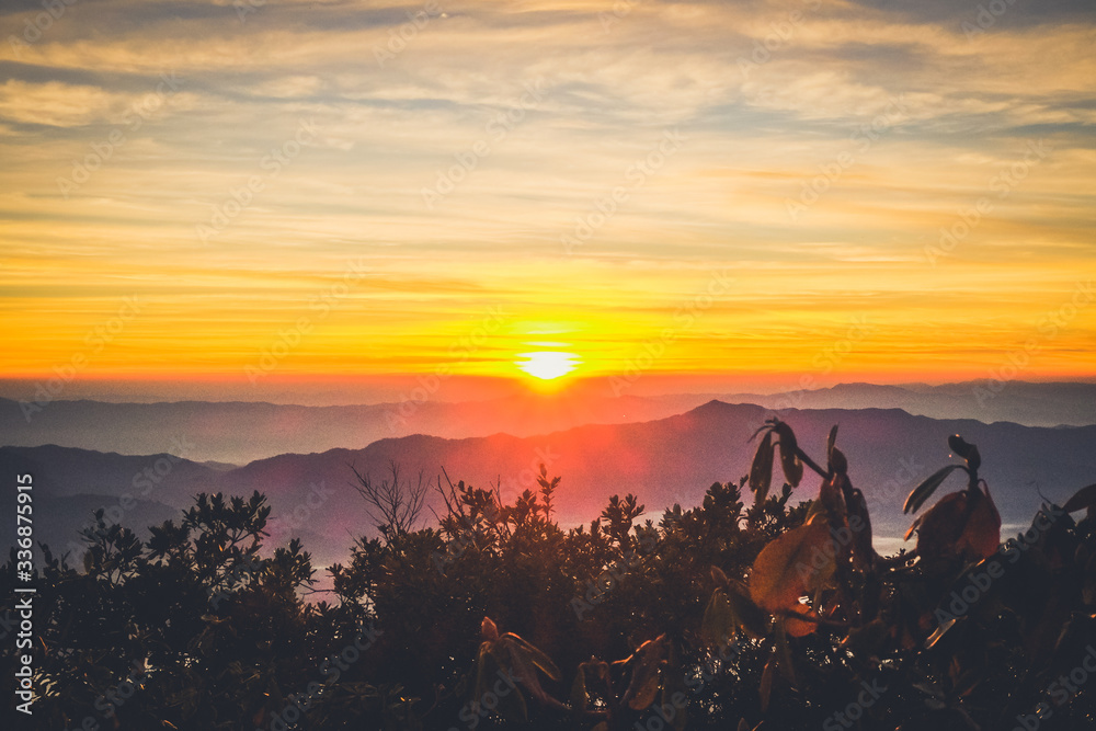 Poster sunrise backlit sky with cloud on the top of mountain