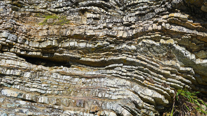 Stone texture, abstract background, uneven lines, bends of stone layers. Natural pattern for your product. wavy structure of layers of stone