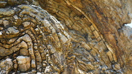 Stone texture, abstract background, uneven lines, bends of stone layers. Natural pattern for your product.Curved soft lines in rock, frozen volcanic lava