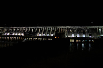 Fototapeta premium View of the illuminated Itaipu Dam at night. The biggest hydroelectric dam, on the Parana River located between Brazil and Paraguay.