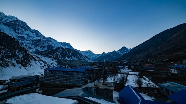 Day to Night Timelapse of Manang Valley with Tilicho peak and stars in the background. Dusk till dawn Timelapse. Ultra Wide Shot.