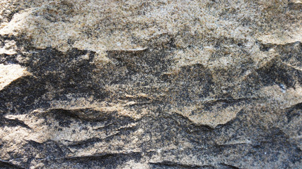 Close-up texture wild mountain stone, relief, sharp lines