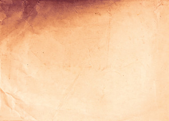 Old burned paper texture. Vintage paper background. Warm toned photo.