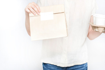 Close up of young woman hold food delivery and coffee package isolated on white background, Use online application for food delivery service.