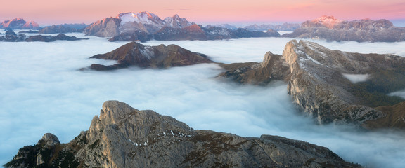 View of famous Dolomites mountain peaks glowing in beautiful golden morning light at sunrise in...
