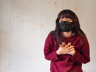 Woman wearing face mask and can't breathe. Healthcare, environmental, ecology concept. COVID-19 Pandemic Coronavirus.