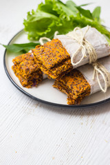 Crunchy crispy breads or flax seeds flatbreads on plate. Vegan food. Salad leaves