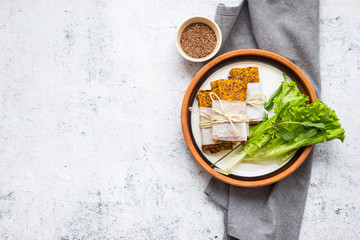 Crunchy crispy breads or flax seeds flatbreads. Vegan food. Copy space. Green salad leaves