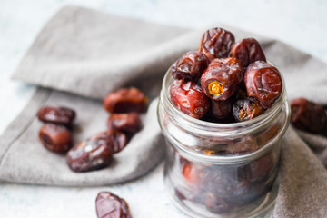 Date fruites, dates or sweet Iranian hurma in glass jar. Natural organic dieting dessert food. Vegan meal.